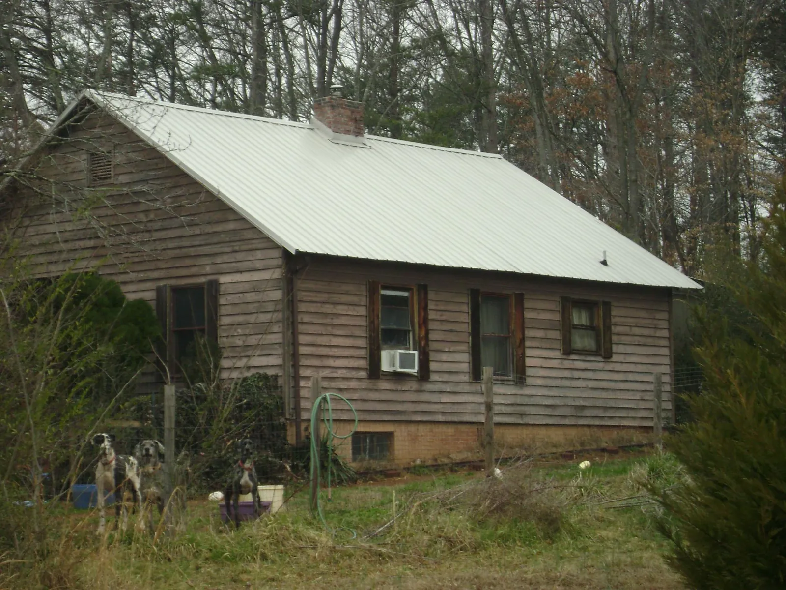 White metal roof on an old wood sided farmhouse, from a Metal Roof Installation job in Maria Stein